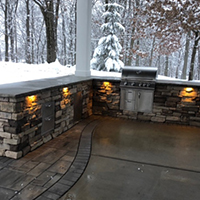 Custom Built Bar with Stone Masonry, Lighting, Cabinets, and a Built-in Grill
